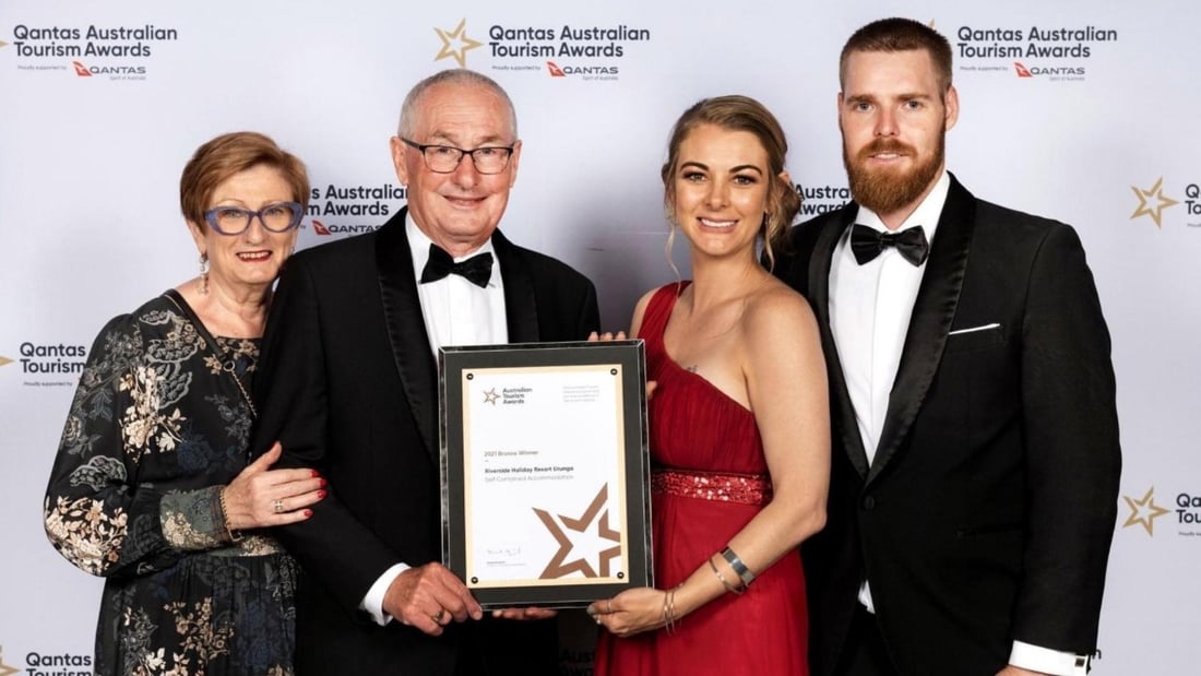 CEO Ken Conway with partner Beth, and Riverside Holiday Resort Manager Rebecca Beaton with partner Bo accepting the Bronze Award at the at the Australian Tourism Awards 2021 ceremony on the Sunshine C