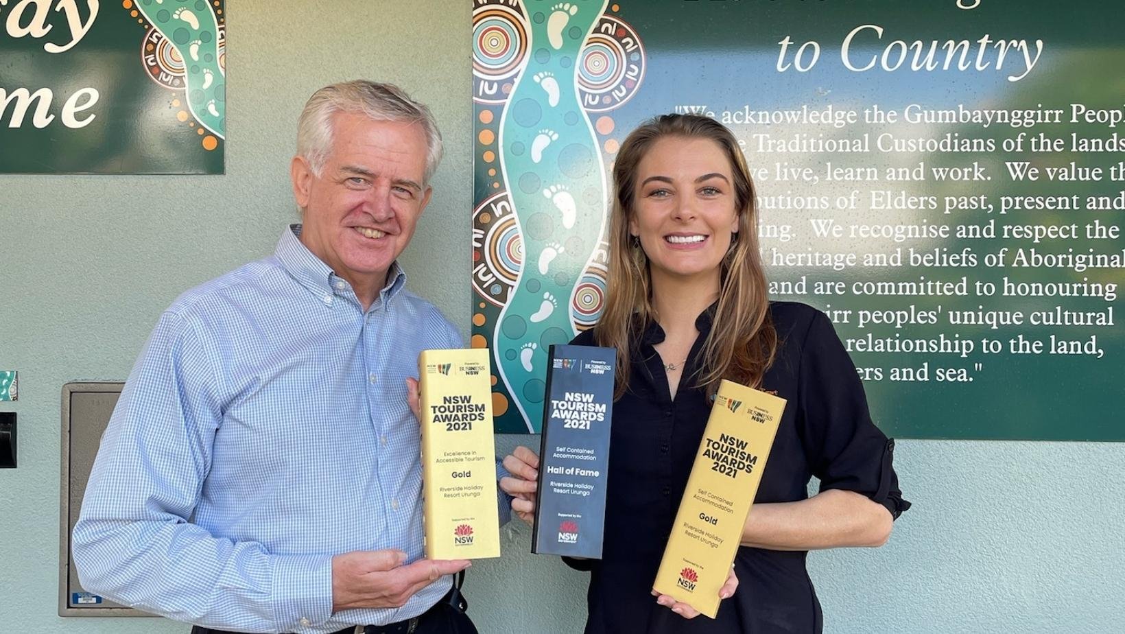 Kellon Beard from Business NSW and Riverside Holiday Resort Manager Rebecca Beaton receiving the Gold Award for Self-Contained Accommodation and Excellence in Accessible Tourism, plus Hall of Fame Awa