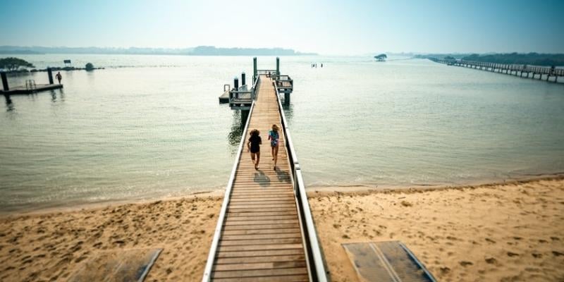 Blog Social Stories - My Holiday at Riverside Holiday Resort in Urunga - Accessible jetty and pontoon with ramps to the sand and the 1km accessible boardwalk to the right